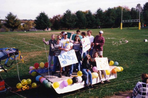 Juniors stand on their homecoming float , supporting their class during Spirit Week 1996.