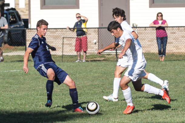 International student and senior Guillermo Almirall takes the ball up the field.  Varsity soccer lost this game 2 to 1 against Mount St. Joseph High School on Sept. 23. 