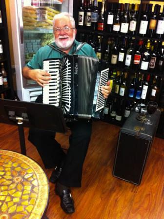 Religion teacher Richard Gatto plays his accordion at Savona in Bel Air. Gatto and his band perform at events regularly. 