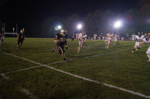 Paul Lorick 15 runs with the ball during the Friday night game against St. Pauls last year. JC played all their home conference games under the lights last season and will play in the first night game on senior night against Boys Latin. 