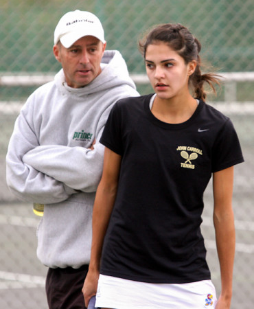 Freshman Alexis Martinez, varsity singles tennis player, consults with coach George Panian. Martinez is taking a short break from her championship match.
