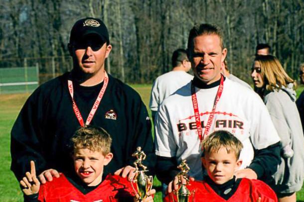 Bill Lewis (top left), who will be the varsity football coach for the 2014 season, wins the championship in the Harford-Baltimore County Youth Football League with his Bel Air youth team in 2003. Also pictured are coach Steve Jacobs (top right) and players Brandon Lewis (bottom left) and Ryan Jacobs (bottom right). Lewis is replacing varsity head coach Rich Stichel, Jr.