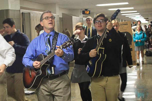 Social+studies+teacher+Bob+Schick+and+sophomore+Conrad+Gagnon+walk+the+halls+singing+Its+Thursday+on+Dec.+5.+Schick+made+up+the+song+at+the+beginning+of+the+year+and++sings+it+each+Thursday+morning.