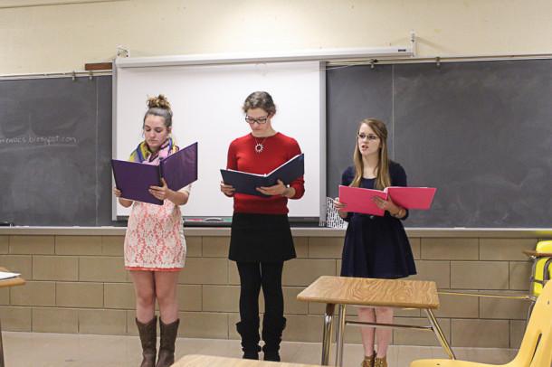 Seniors Casey Reil, Margaret McGuirk, and Kayla Bynion perform a Catch-22 piece for the Readers Theater event. The trio placed second overall.