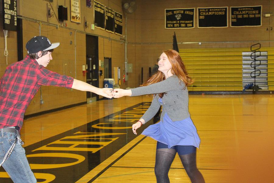 Senior Jessie Clingerman and her dancing partner Pat Collins spin on the dance floor during the Swing Dance on Feb. 21.  The Swing Dance was held to benefit the senior class. 