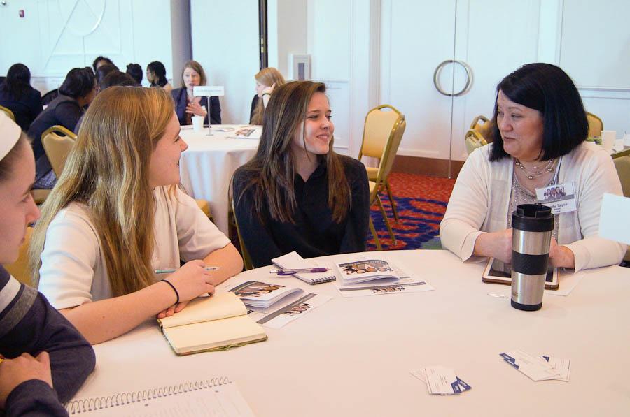 Freshmen Shelby Umbarger and Megan King talk to research scientist Cindy Taylor at Battelles 2014 STEM Womens Forum. Students listened to speakers and talked to them during mentoring sessions. 