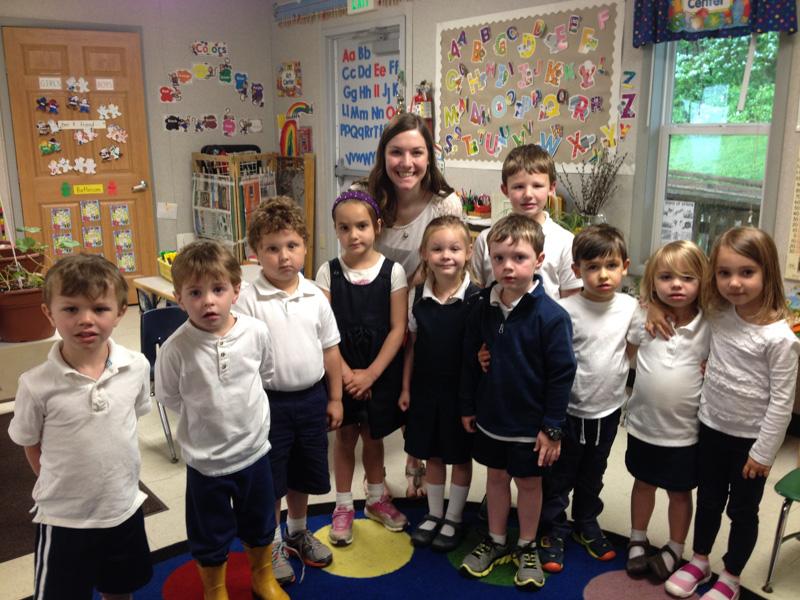 Senior April Moscati poses with the pre-k 4 class at Saint John the Evangelist School. Moscati volunteered at the school, where she worked one-on-one with students, helping them with their writing and reading skills.