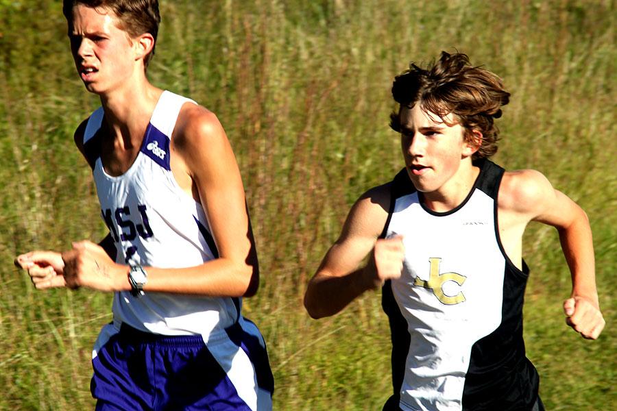 Junior Evan Moore runs past his competition. This year, Moore became the number one varsity runner on the team.