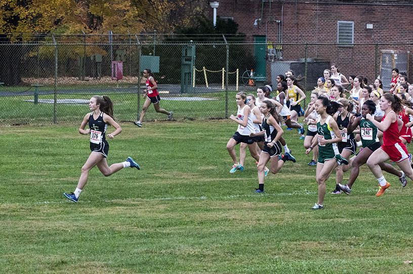 Junior JV runner Grace Glinecki sprints to the front of her race just as the gun goes off on Oct. 29 at Oregon Ridge State Park. The girls cross country team finished sixth in their championship meet.