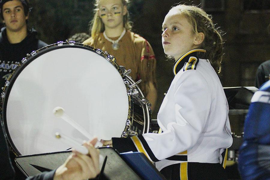 Sophomore Emma Gromacki plays the bass drum at the Homecoming football game on Oct. 24. Gromacki has participated in drum line during both of her years at JC.