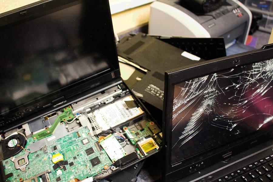 These laptops have been returned to the Tech Lab broken. Help Desk Coordinator Joseph Vitucci has then gutted them to try to salvage different parts.