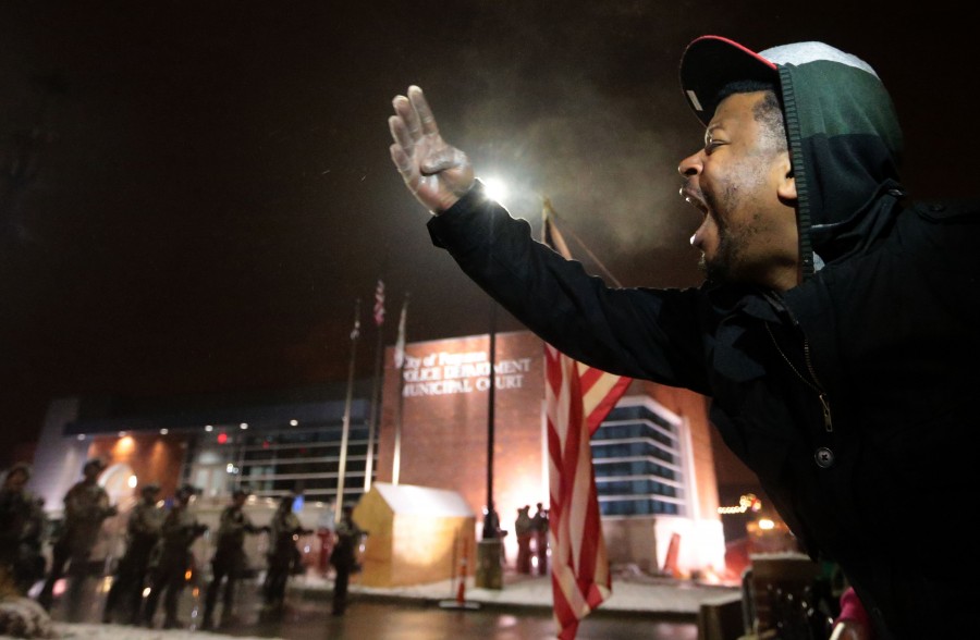 &quot;This must stop,&quot; yells a protester to the Missouri National Guard who were posted outside the Ferguson Police Station on Wednesday, Nov 26, 2014. Gov. Nixon has been criticized for the timing of their arrival. (Laurie Skrivan/St. Louis Post-Dispatch/TNS)