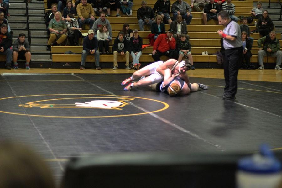 Senior+heavyweight+wrestler+Christian+Scott+takes+his+opponent+down+on+his+way+to+victory.+Scott+is+a+three+time+all-county+wrestler+and+competed+in+the+BTC+All-Star+game+for+football+this+year.