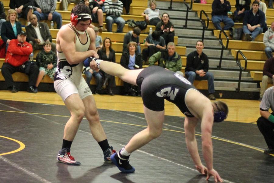 Dragging his opponent back into the middle of the mat, senior Hunter Ritter wrestles his way into Patriot history. Ritter won his 206th match, surpassing the record of Matt Miller, class of 12, for the most wins in four years. 