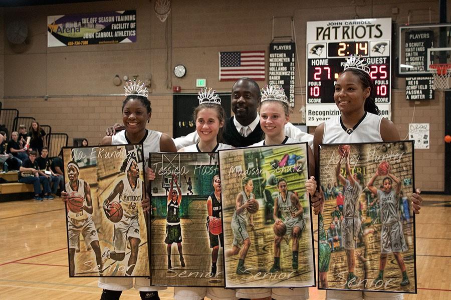 Seniors+Oladokun+Ekundayo%2C+Jessica+Hastings%2C+Madison+Schutz%2C+and+Ashley+Hunter+%28left+to+right%29+show+off+the+personalized+portraits+they+received+at+their+senior+night+game+from+varsity+coach+Craig+Simmons+%28back%29.+The+team+played+St.+Vincent+Palotti+on+their+Senior+Night+on+Feb.+3.