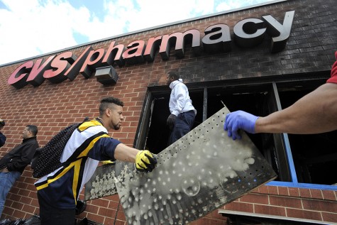 Volunteers work to help clear out debris from the CVS on North Avenue on Tuesday, April 28, 2015, in Baltimore. The store caught fire during Monday's riots. (Lloyd Fox/Baltimore Sun/TNS)