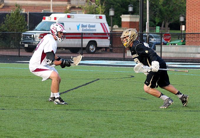 Senior attacker Carson Walton attempts to drive past an Archbishop Curley defender. The mens lacrosse team won the MIAA B conference championship 20-13 against Archbishop Curley on May 15. 