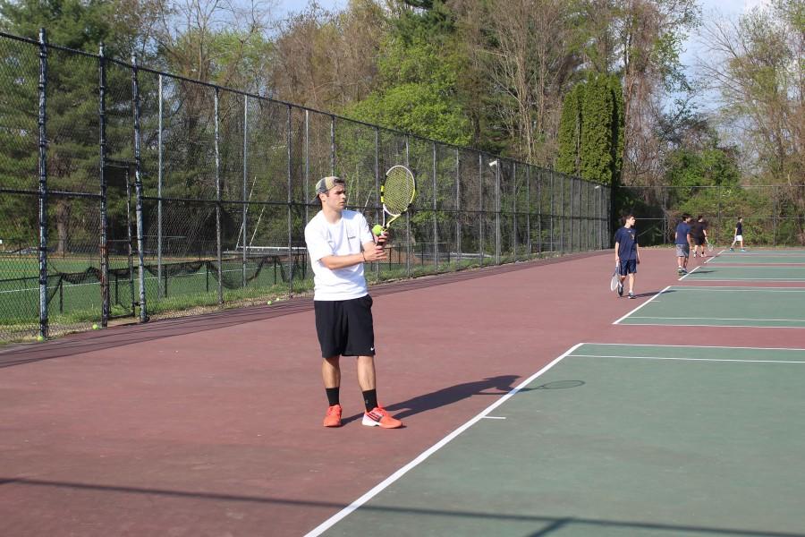 Senior Brendan Wille prepares to serve the ball in the last home tennis match. The match was against Beth Tfiloh, and JC lost 3-2.