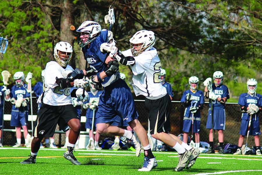 With his team on its way to an 8-7 victory, senior varsity defender Mark Bower knocks his opponent down in a crucial stop late in the fourth quarter against Saint Peter and Paul on April 17. Later that month on April 24, the lacrosse program hosted Youth Day for 175 local middle school lacrosse players to show that JC should be an option for them for high school.