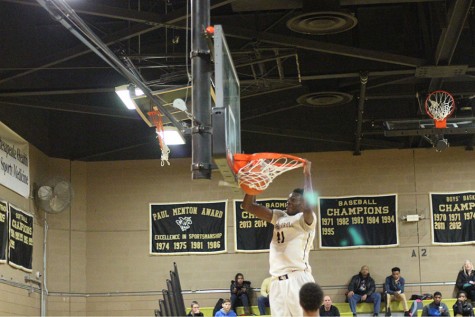 Senior Michael Tertsea dunks the ball during last years home game against Mount St. Joe. Tertsea has recently committed to Rhode Island University to play collegiate basketball.