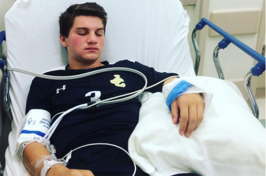 Junior Franco Caltabiano lies in a hospital bed. Caltabiano was rushed to the ER after suffering an injury during a soccer game on Sept. 25 against Mount Saint Joseph.