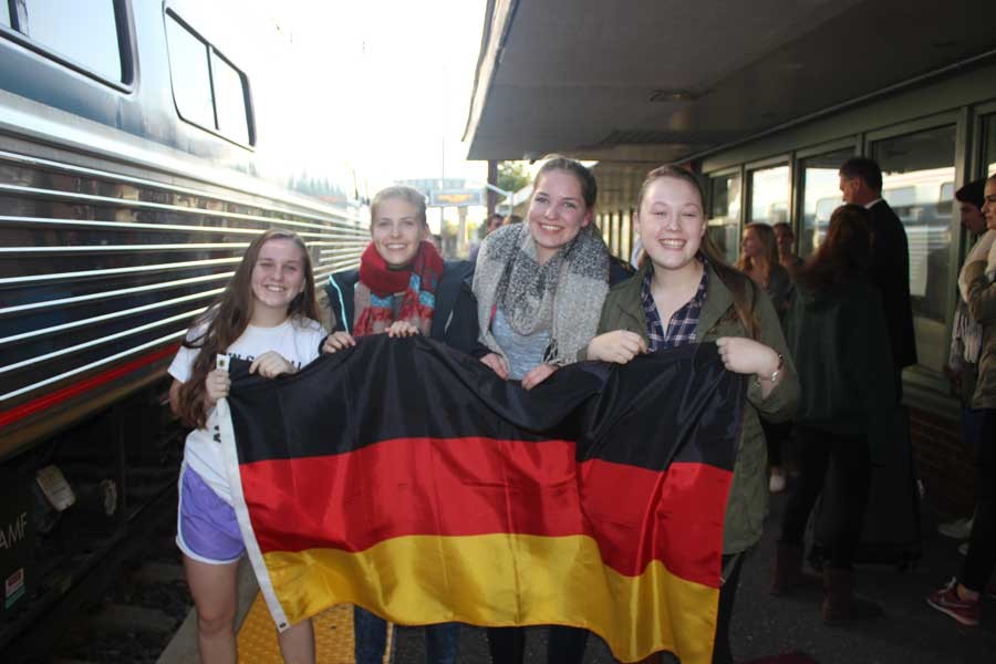 Juniors Leah Monaghan and Katherine Grimm hold up the German flag with their exchange students Merle Rohde and Victoria Schiedeck. Monaghan and Grimm brought the flag with them to the train station to pick up their exchange students and welcome them to Bel Air. 