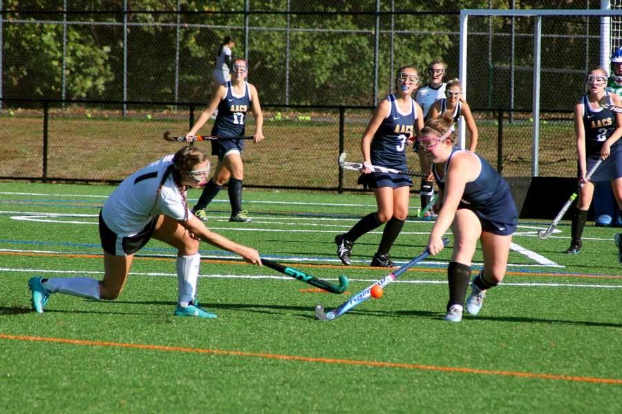 Senior+right+midfielder+and+team+captain+Carly+Lyon+flicks+the+ball+to+the+left+of+the+defender+to+carry+the+ball+into+the+circle.+The+varsity+field+hockey+team+played+against+Annapolis+Area+Christian+School+on+Wednesday+and+won+5-1+to+maintain+their+undefeated+record.