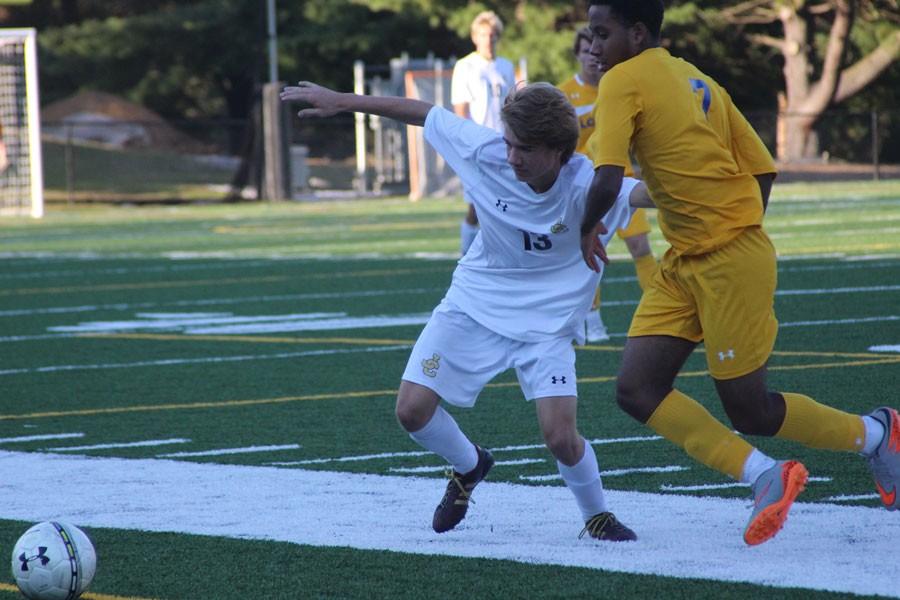 Junior midfielder Seth Anderson runs past a Loyola defender in order to gain possession of the ball. JC played Loyola on Oct. 16, and lost 3-1.