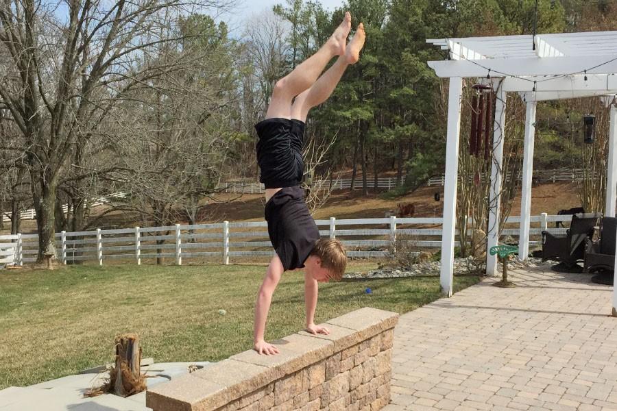 Holding himself up, sophomore Josh Pattisall does a handstand on a brick wall. Pattisall has been doing parkour and freerunning for the last two-and-a-half to three years. 
