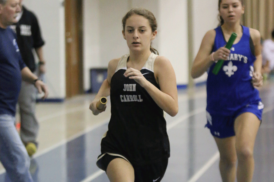 Sophomore+Paige+Alban+runs+during+a+long+distance+relay+competition.+The+womens+indoor+track+team+finished+the+championship+meet+at+fourth+overall.