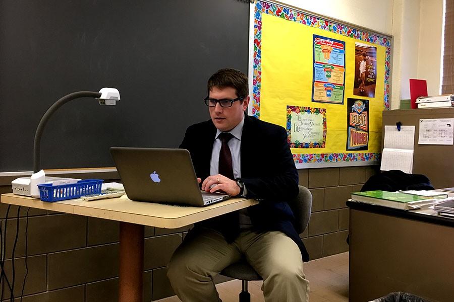 During class, Vice Principal of Technology and Student Affairs Brian Powell searches for political ad campaign videos to teach his AP Government and Politics students. Powell, along with being a teacher, is an administrator, has a side design company, and farms as a hobby.