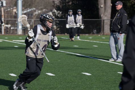 Sophomore midfielder Jake Kreiger carries the ball down the field during practice on March 8. Kreiger was one of four freshmen to make the varsity team last year.