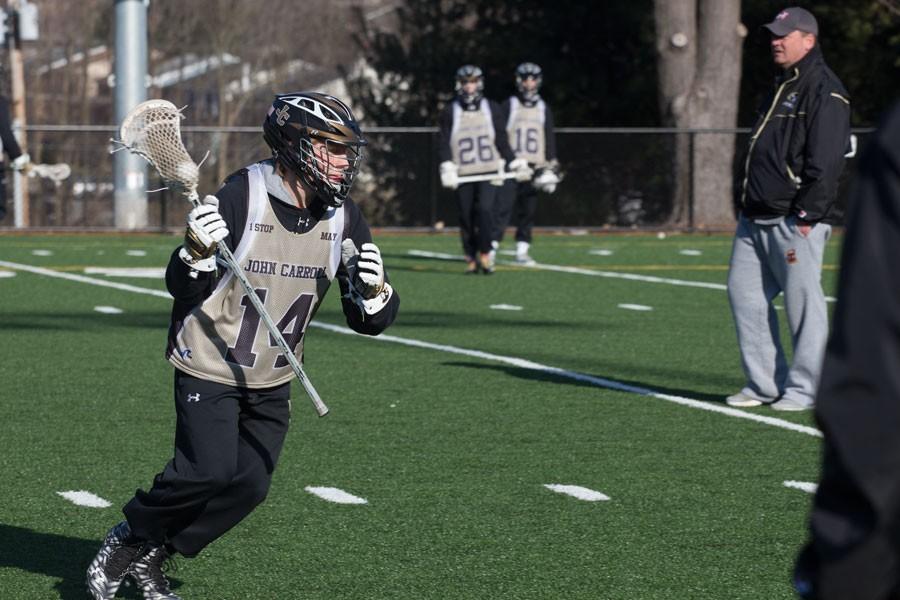 Sophomore+midfielder+Jake+Kreiger+carries+the+ball+down+the+field+during+practice+on+March+8.+Kreiger+was+one+of+four+freshmen+to+make+the+varsity+team+last+year.