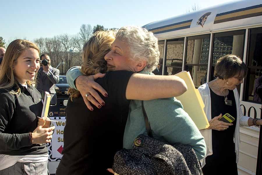 Holocaust survivor Vera Kestenberg arrives and embraces her guide, senior Madison Hooper. On March 1, 18 speakers came to share stories from the Holocaust and the aftermath of the genocide of six million Jews and five million others. 