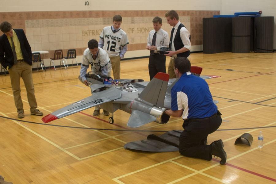 Junior Max Moxey and his father Victor Moxley demonstrate the mechanics of their model-sized Navy jet for the STEM program. Moxley brought in the jet to demonstrate his hobby to the STEM students. 