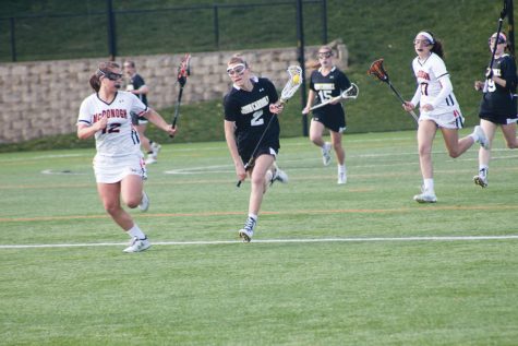 Junior Abby Hormes charges forward with the ball on a fast break. The Patriots fell to McDonough, 16-10, on April 8.