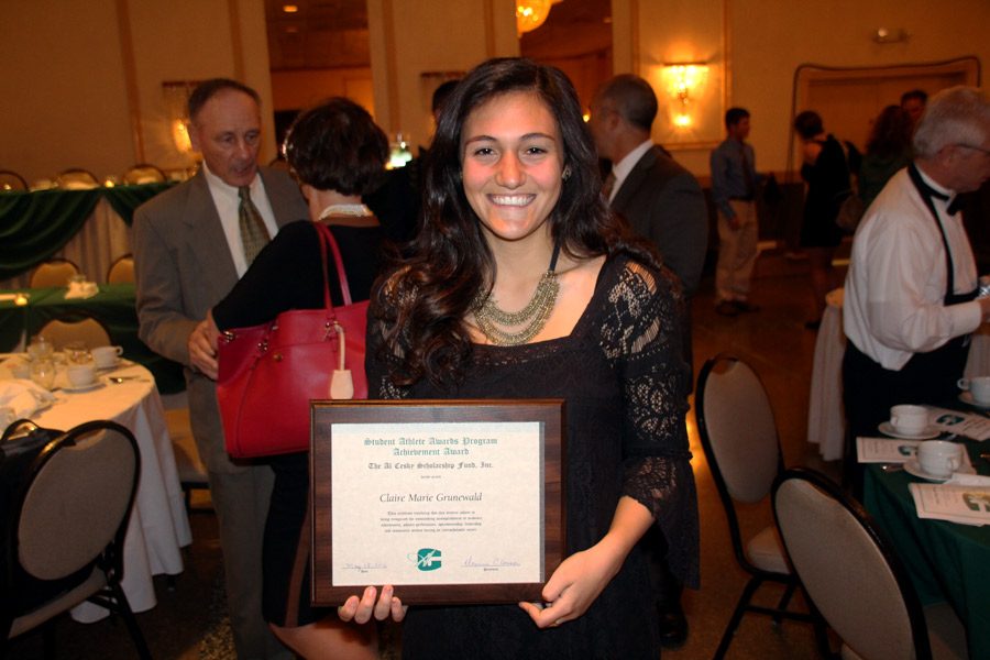 Senior Claire Grunewald poses with the Al Cesky Scholarship Fund plaque. Along with Grunewald, senior Kurt Rawlings was the overall male winner and received a $5,000 scholarship.