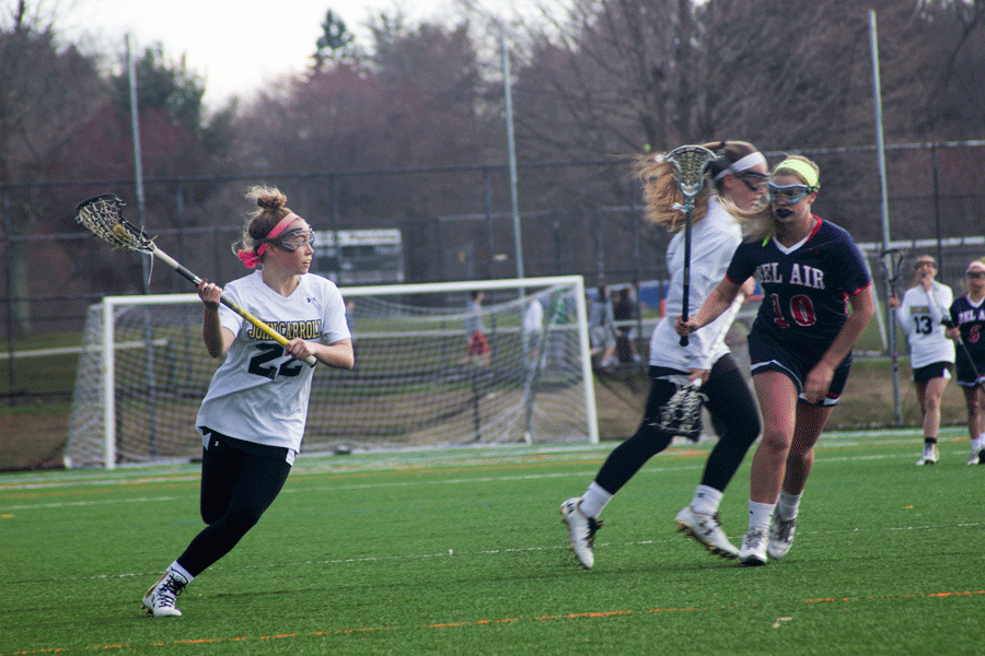 Senior attackman Mary Kate Gerety looks towards the goal for an open player. The womens lacrosse team finished with a 10-8 record after being eliminated in the playoffs.