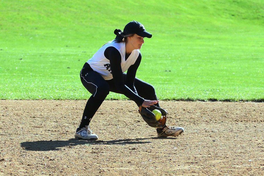Sophomore varsity shortstop Meghan Sheehan fields a ground ball and prepares to throw to first base. The softball team finished the season with a record of 5-13.