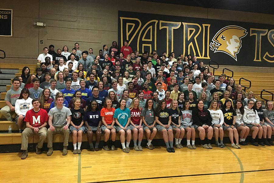 The+senior+class+poses+on+the+upper+gym+bleachers+for+the+annual+Decision+Day+picture.+Decision+Day+is+the+day+when+seniors+wear+a+shirt+displaying+the+name+of+the+college+they+will+attend.