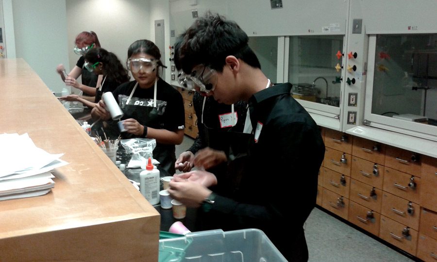 Level 1 sophomores Suky Pei, Ryan Xu, and Alex Yuan (left to right) work on a lab experiment called Viscoelastic Bounce, where they made bouncy balls out of glue. The Level I team placed second for their bouncy ball.  