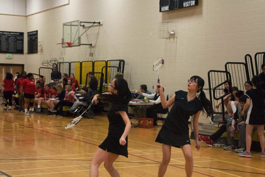 Senior doubles team Lucy Chen and Vanilla Tong prepare to smash back the shuttlecock. The badminton team finished with a 6-2 record on the season.