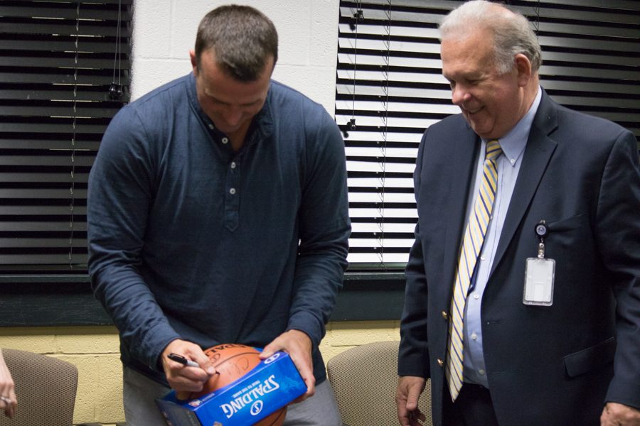 Former NBA player Chris Herren signs memorabilia for local students before his presentation. The Harford County Sheriffs Department organized an event on May 18 to fight the heroin epidemic in our county according to Bel Air Chief of Police Charles Moore. 