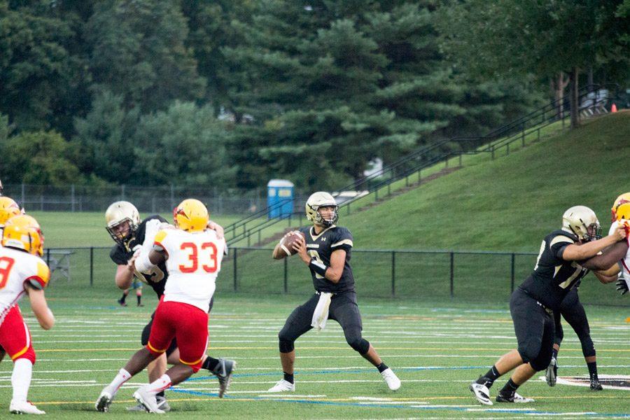 Junior quarterback Qadir Ismail winds up to throw to an open receiver against Calvert Hall on Sep. 9. Ismail transferred from Patterson Mill High School to JC this year.
