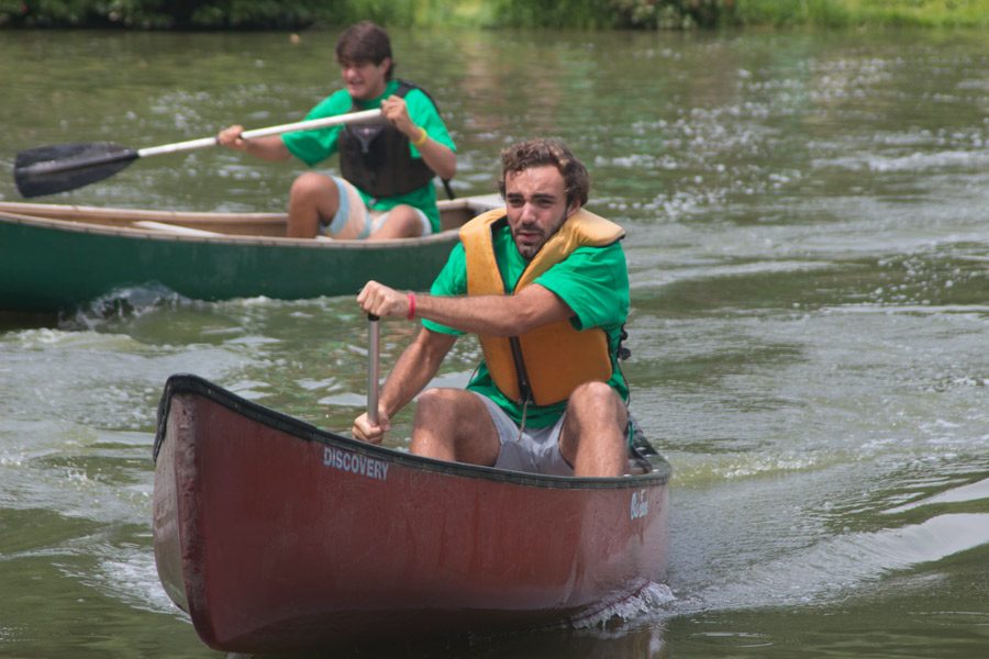 Seniors Nate Lebuhn and Chris Tassanari paddle across a lake during a canoe race. Four sets of boys and four sets of girls were chosen from each group of seniors and competed in two relay races against one another.