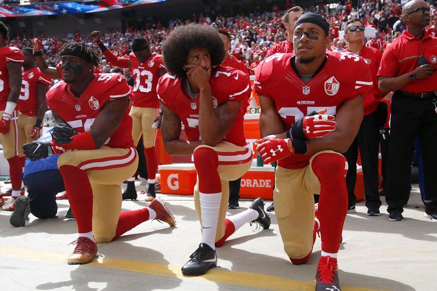 From left, the San Francisco 49ers Eli Harold, Colin Kaepernick and Eric Reid kneel during the national anthem before their NFL game against the Dallas Cowboys on October 2, 2016, at Levis Stadium in Santa Clara, Calif.