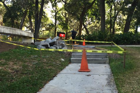 Caution tape blocks off one of the pathways on Jacksonville Universitys campus after it was damaged from Hurricane Matthew. Those affected by the storm have begun cleaning up the aftermath and repairing the damages.