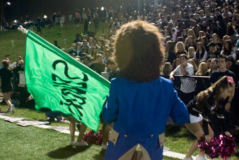 The Patriot mascot waves the senior flag in front of the crowd to try to excite the student section during the Homecoming Game on Oct. 7. The varsity football team was defeated 20-21 by Boys' Latin.