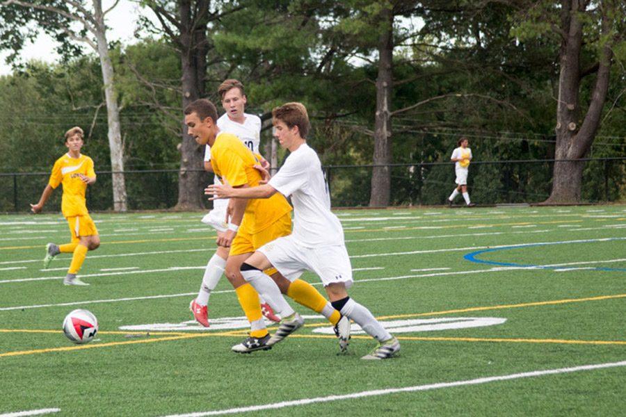 Varsity+soccer+midfielder+Seth+Anderson+fights+for+the+ball+against+a+Loyola+player+on+Sep+16.+The+varsity+soccer+team+finished+their+season+with+a+6-13-2+record.