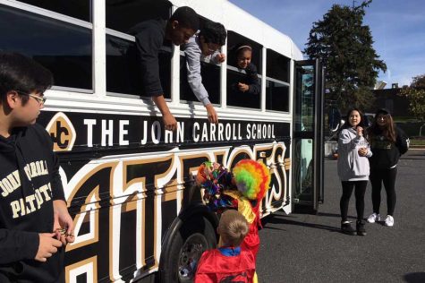 Senior Anthony distributes candy to trunk-or-treaters through the window of the JC school buses. Mountain Christian Church held its annual trunk-or-treat in the teachers parking lot on Saturday, Oct. 29.
